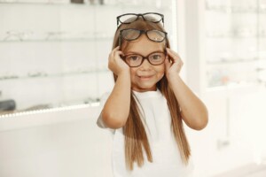 child choosing eyeglasses