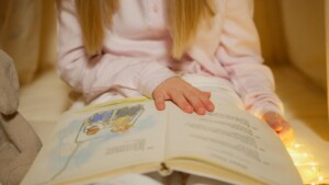 close up shot of a girl holding a story book